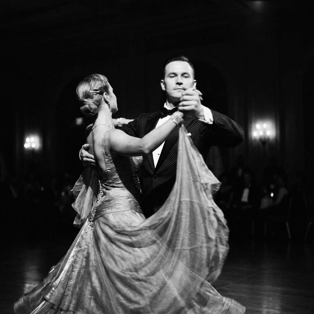 Ballroom dancing couple performing an elegant waltz in dramatic black and white reportage photography